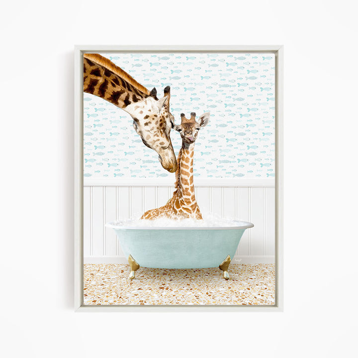 A mother giraffe and her baby giraffe are sitting together in a light blue bathtub, with the mother gently licking her baby.