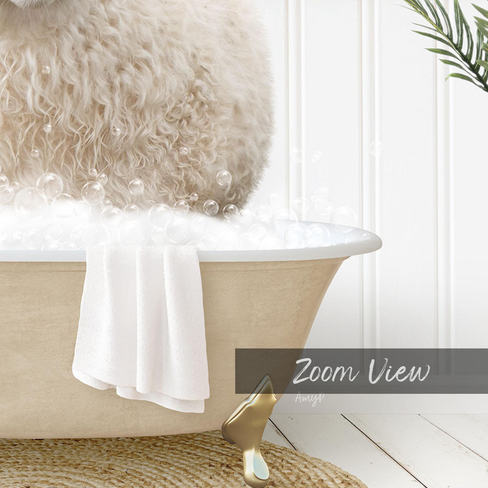 A fluffy white dog is sitting in a bathtub filled with bubbles, with a towel and a gold object nearby.