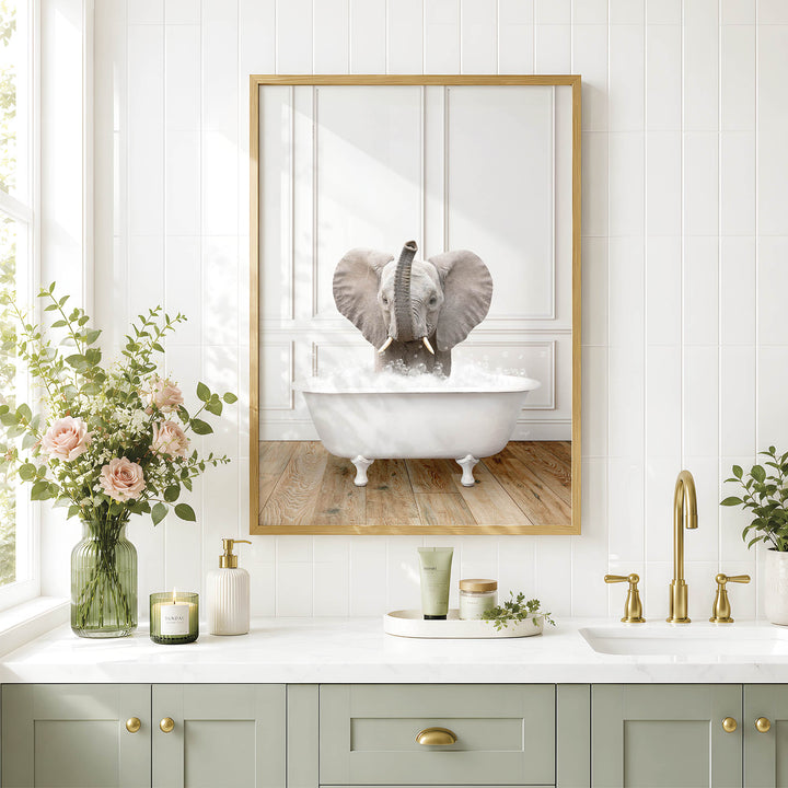 A framed image of an elephant sitting in a bathtub, surrounded by a vase of flowers, candles, and a potted plant, all set against a white tiled wall.