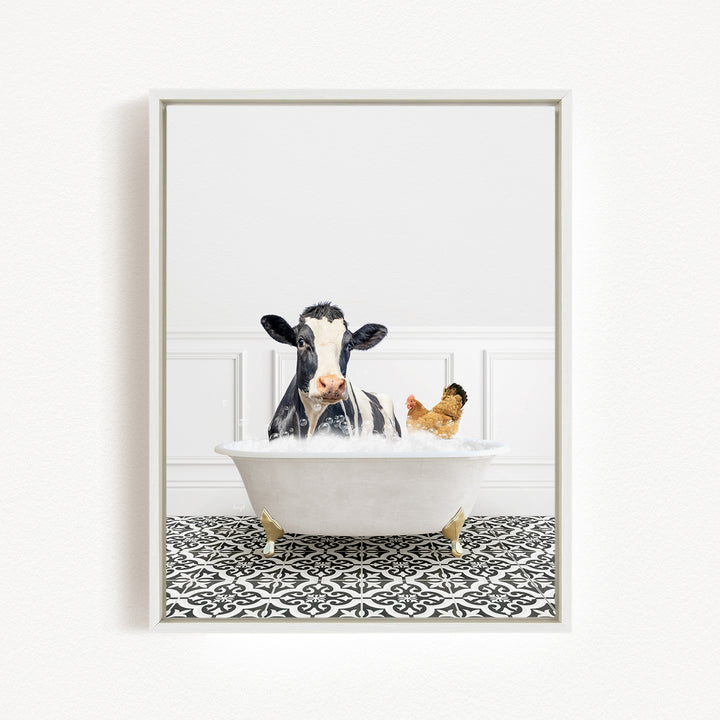A black and white cow is sitting in a white bathtub filled with water, with a chicken nearby.