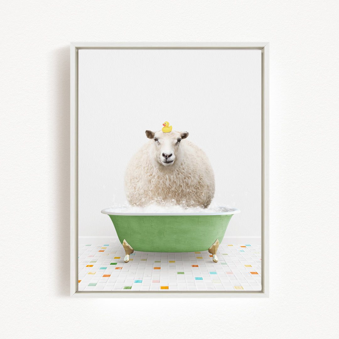A fluffy white sheep sits in a green bathtub filled with bubbles, with a yellow rubber duck perched on its head.