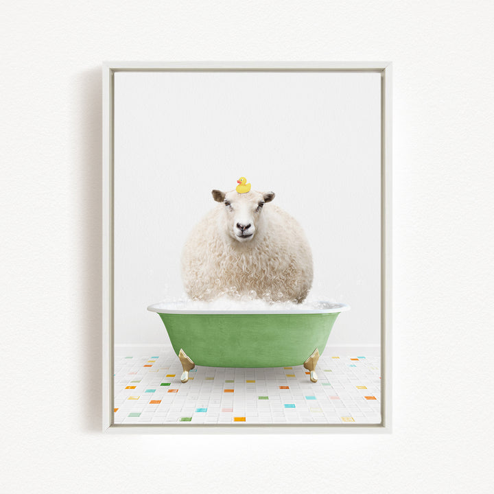 A fluffy white sheep sits in a green bathtub filled with bubbles, with a yellow rubber duck perched on its head.