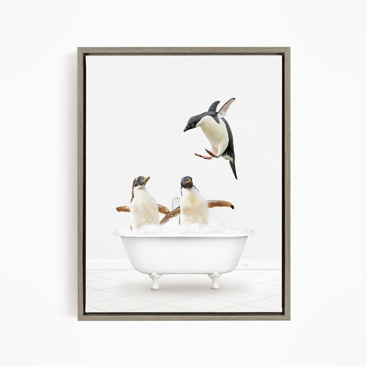 A framed image depicting three penguins sitting in a white bathtub filled with water, with one penguin flying towards the tub.