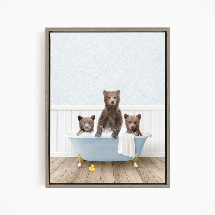 A framed image depicting three brown bears sitting in a blue bathtub, with one bear sitting in the center and the other two bears sitting on either side.