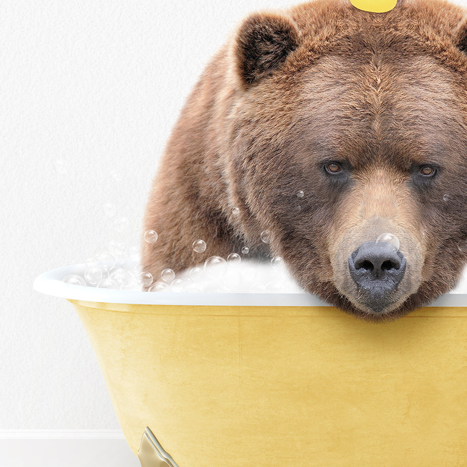 a brown bear is taking a bath in a yellow tub