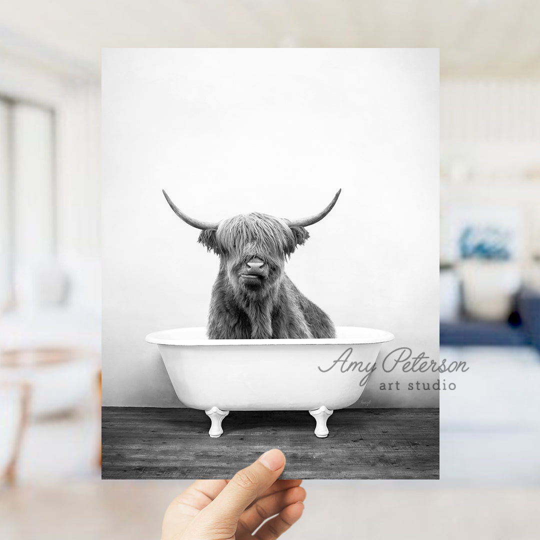 a black and white photo of a cow in a bathtub