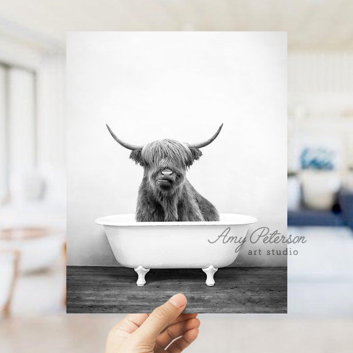 a black and white photo of a cow in a bathtub