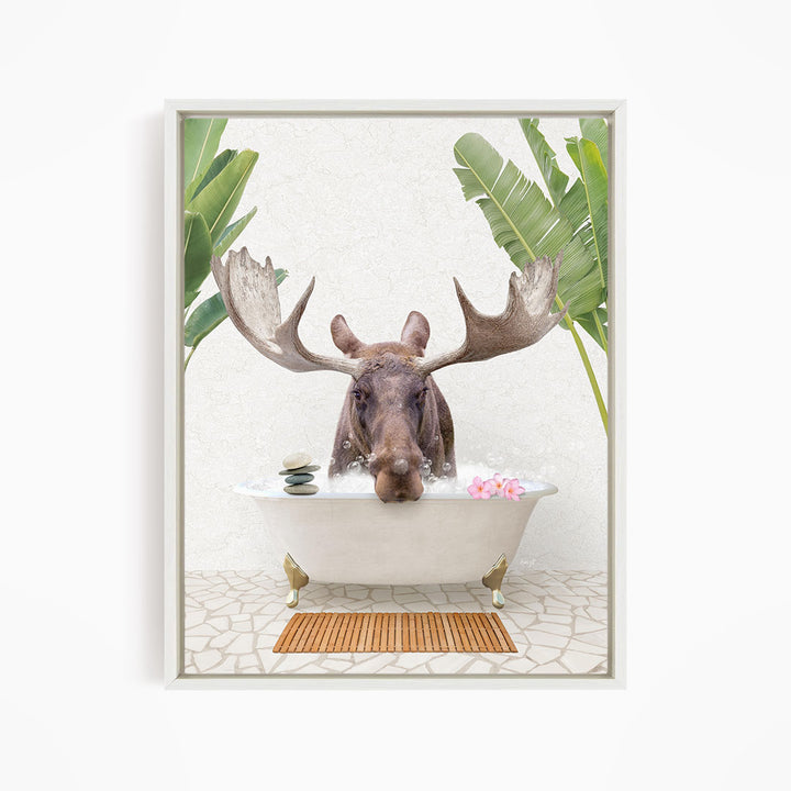 A moose with large antlers is sitting in a bathtub filled with water, surrounded by tropical plants and flowers.