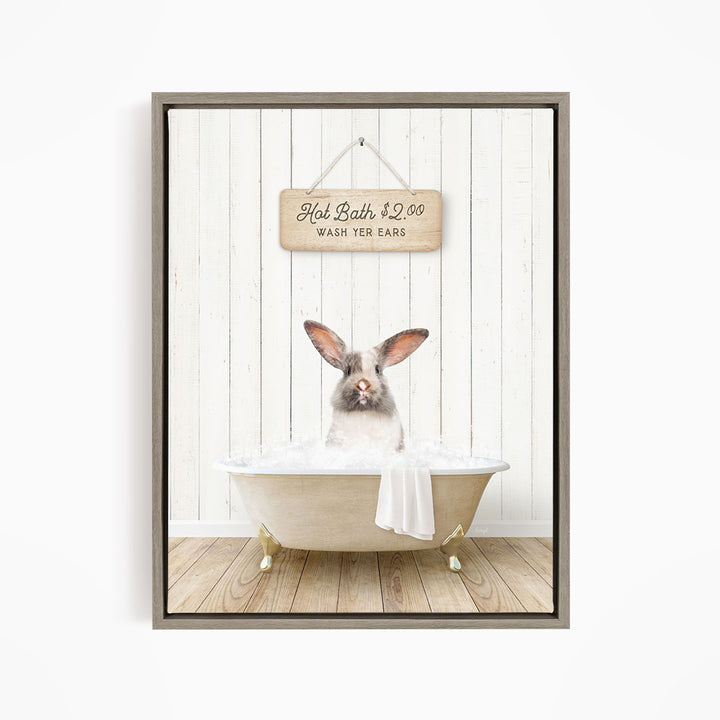 A cute rabbit sitting in a bathtub filled with water, with a sign above that reads "Hot Bath $2.00 WASH EARS".