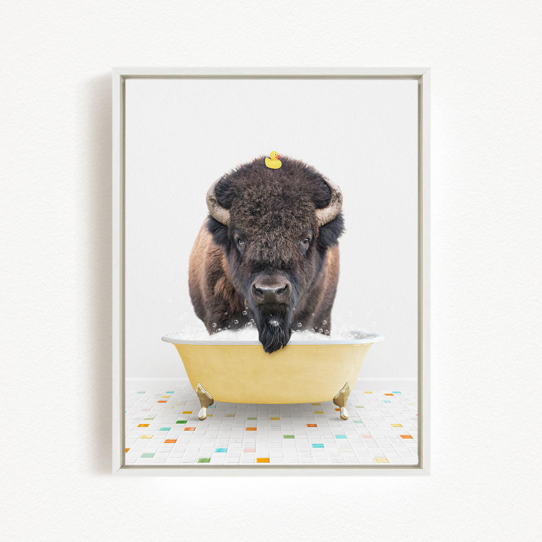 A buffalo with a yellow rubber duck sitting in a yellow bathtub.