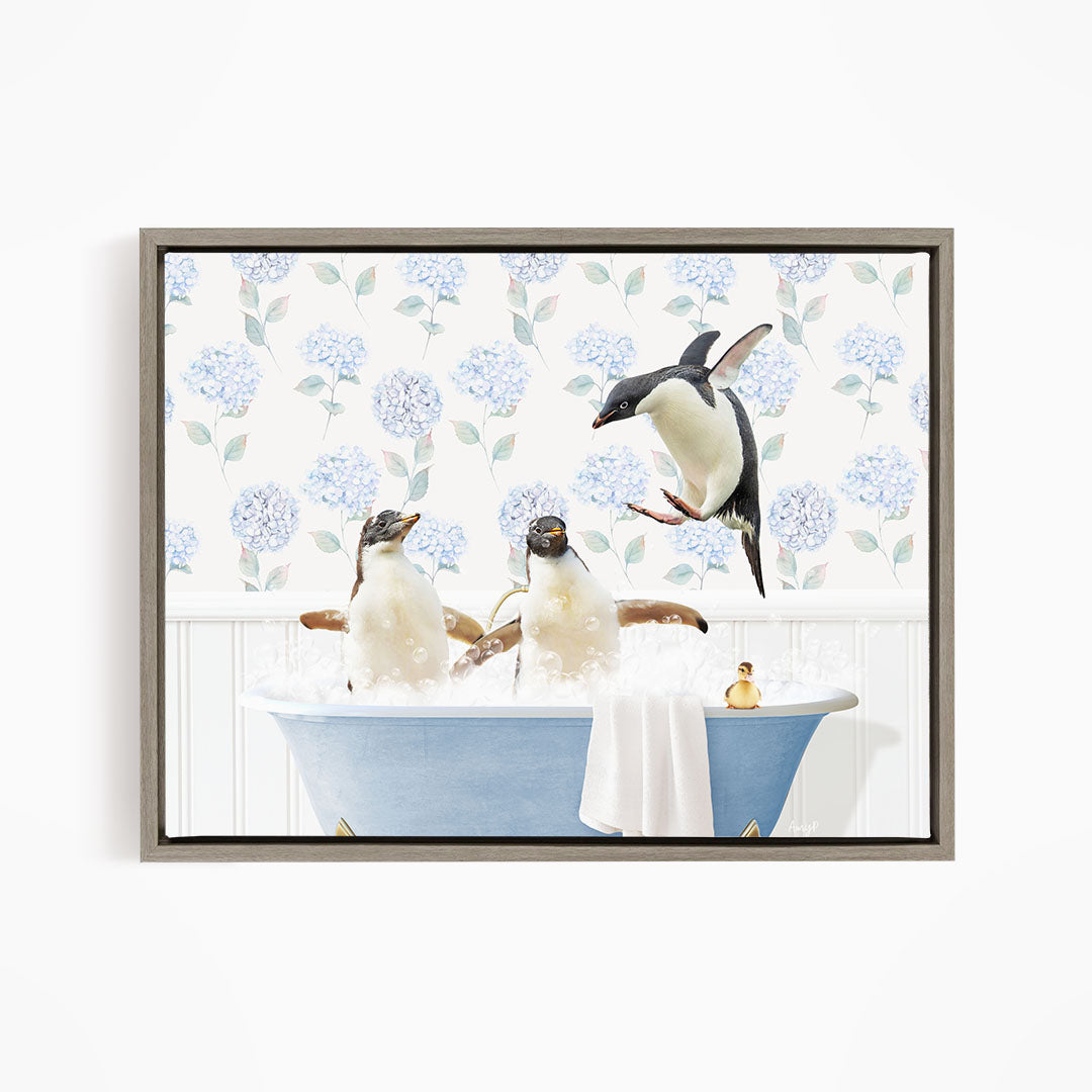 A framed image depicting three penguins sitting in a blue bathtub, with one penguin flying towards the others.