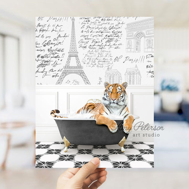 a hand holding a card with a tiger in a bathtub