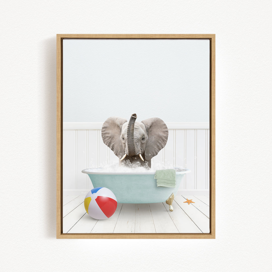 A gray elephant is sitting in a blue bathtub filled with water, surrounded by a beach ball and a starfish.