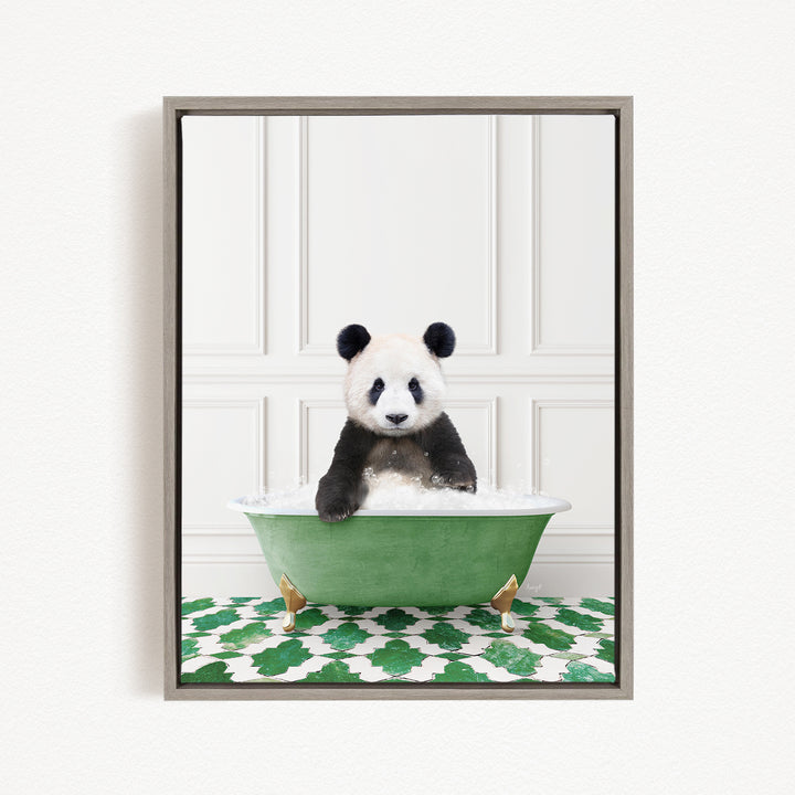 A panda bear sitting in a green bathtub filled with bubbles, surrounded by a green and white patterned mat.