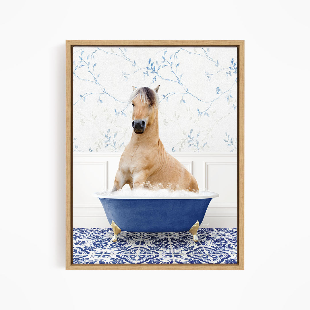 A light brown horse is sitting in a blue bathtub filled with water, surrounded by a blue and white patterned rug.