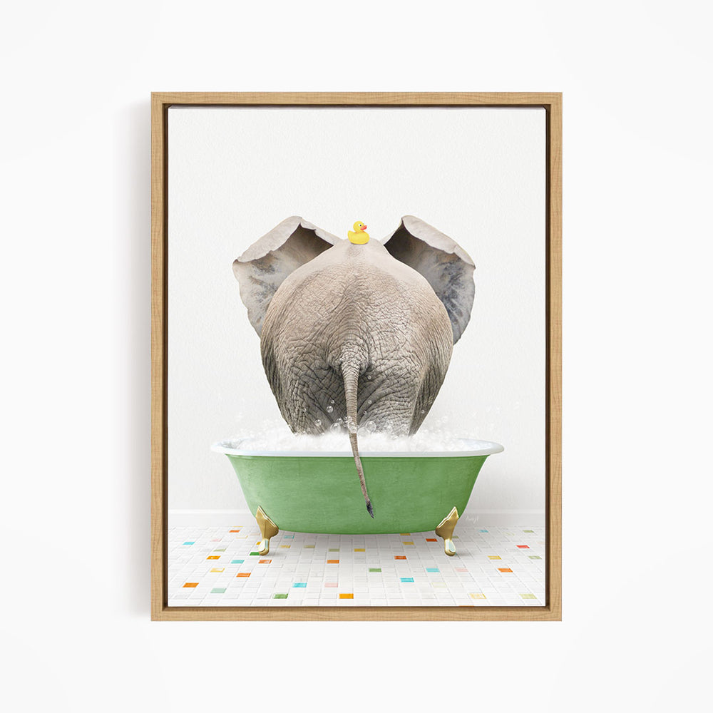 An elephant is taking a bath in a green tub, with a rubber duck floating on its head.