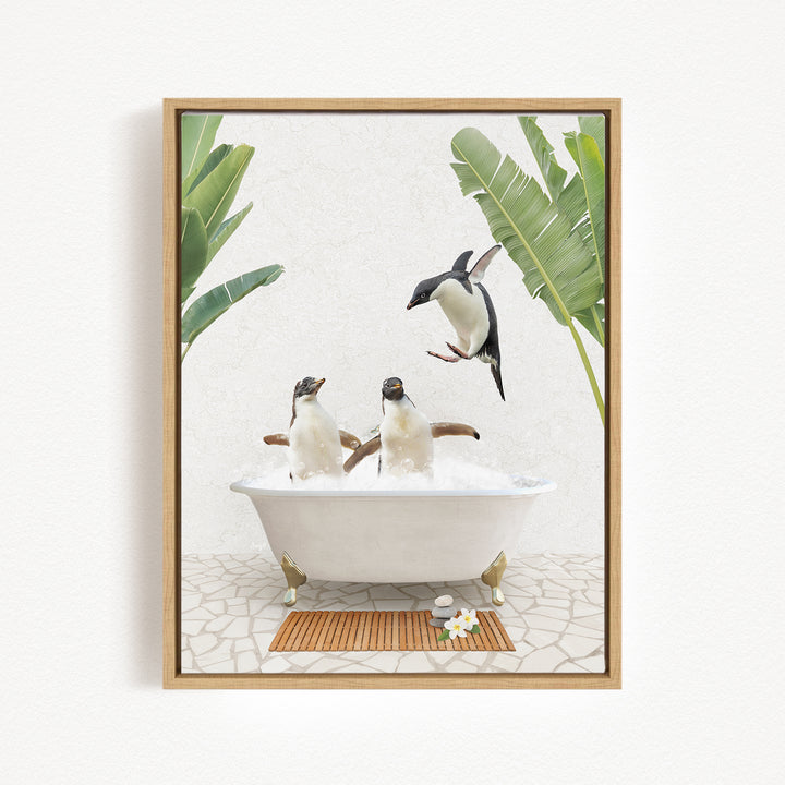 A framed image depicting two penguins sitting in a bathtub, surrounded by tropical plants and a wooden mat.
