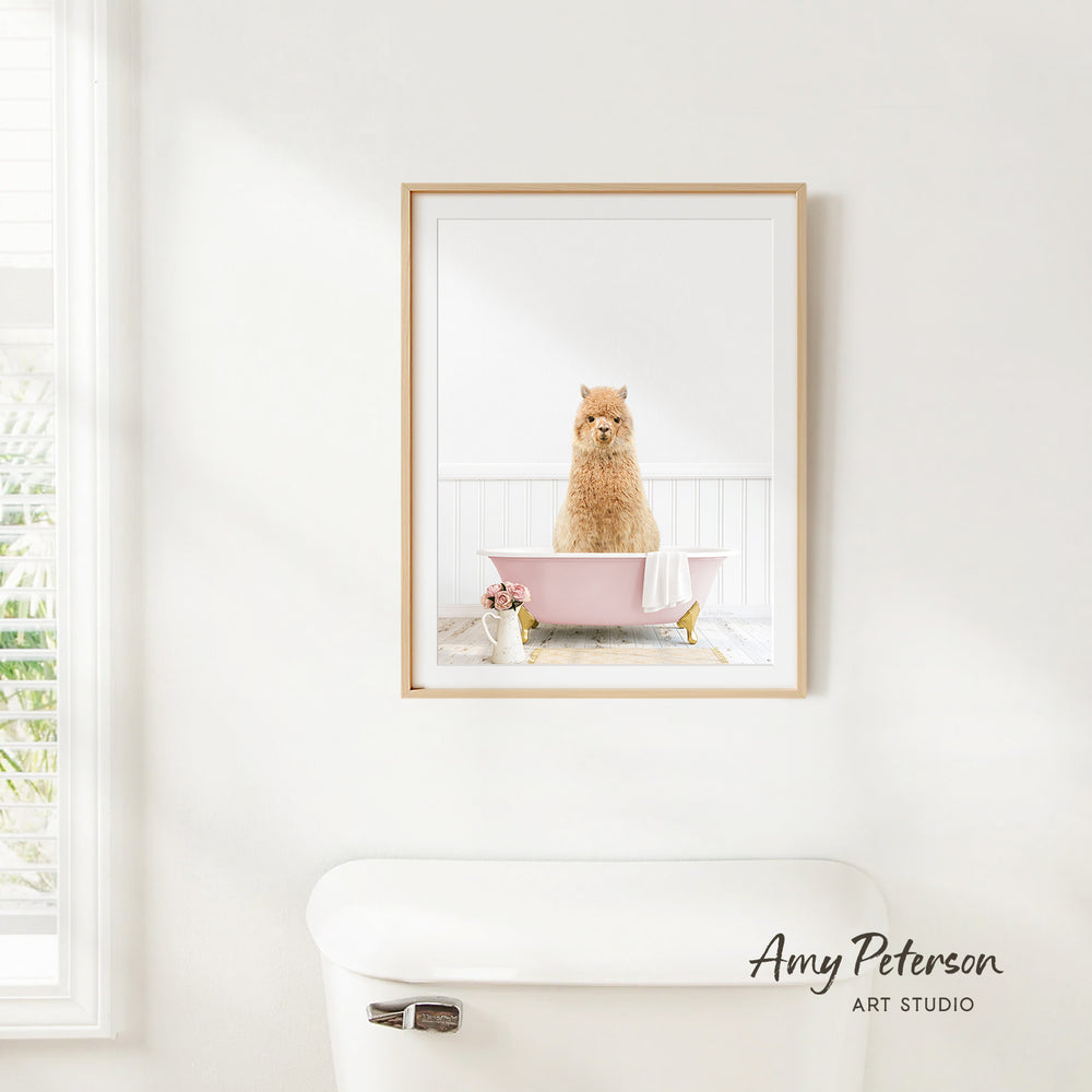 A framed image of a brown dog sitting in a pink bathtub, with a white toilet and a window in the background.