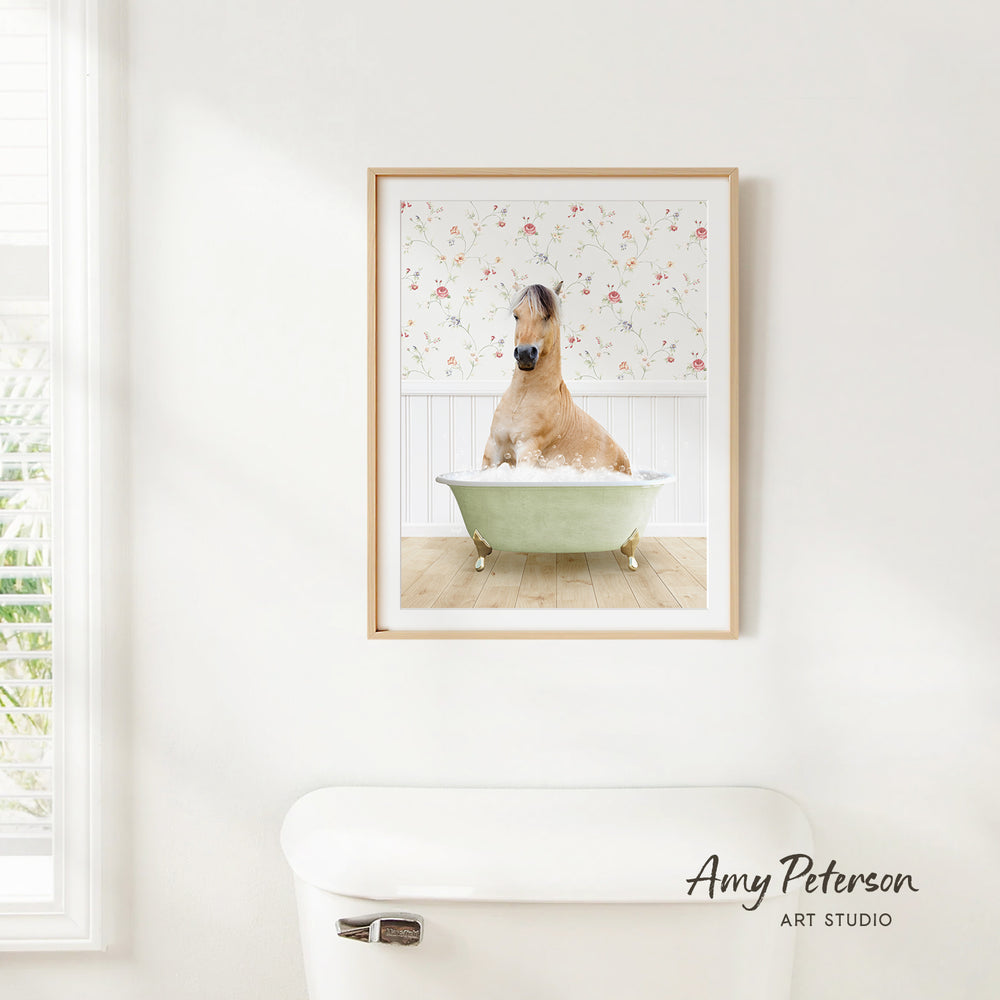 A framed image of a horse sitting in a bathtub, surrounded by a floral pattern on the wall.