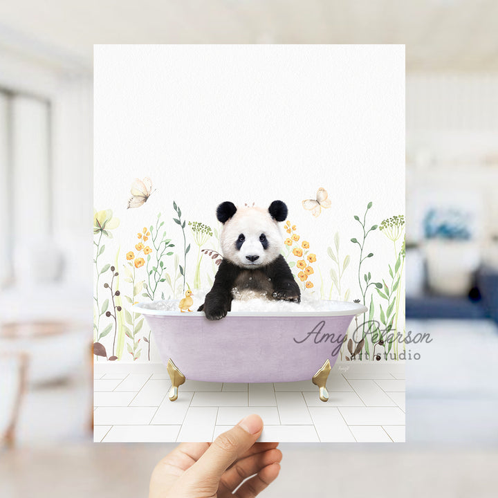 a hand holding a card with a panda bear in a bathtub