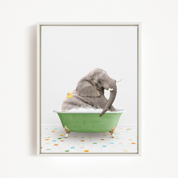 A gray elephant is sitting in a green bathtub, surrounded by colorful tiles on the floor.