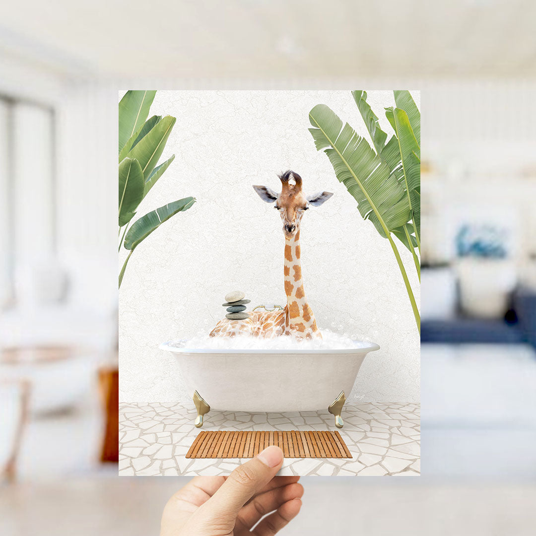 A giraffe sitting in a bathtub filled with water, surrounded by tropical plants.