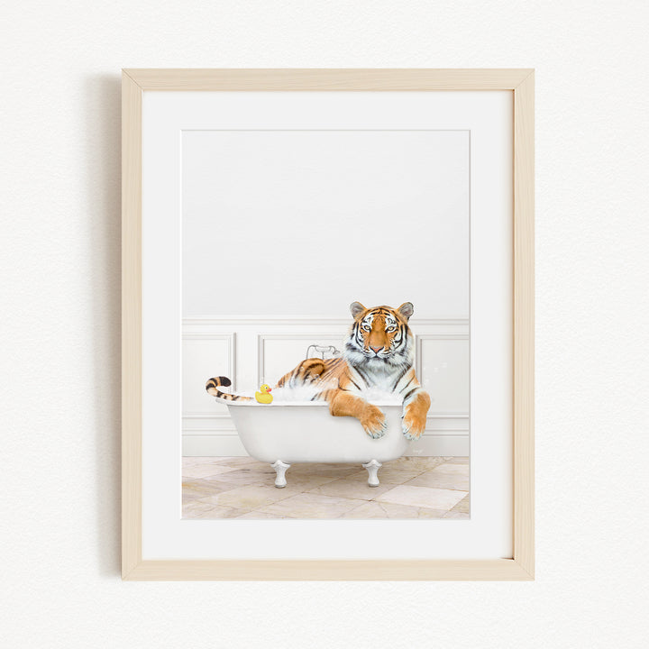 A tiger is sitting in a white bathtub, surrounded by various objects, including a rubber duck and a yellow toy.