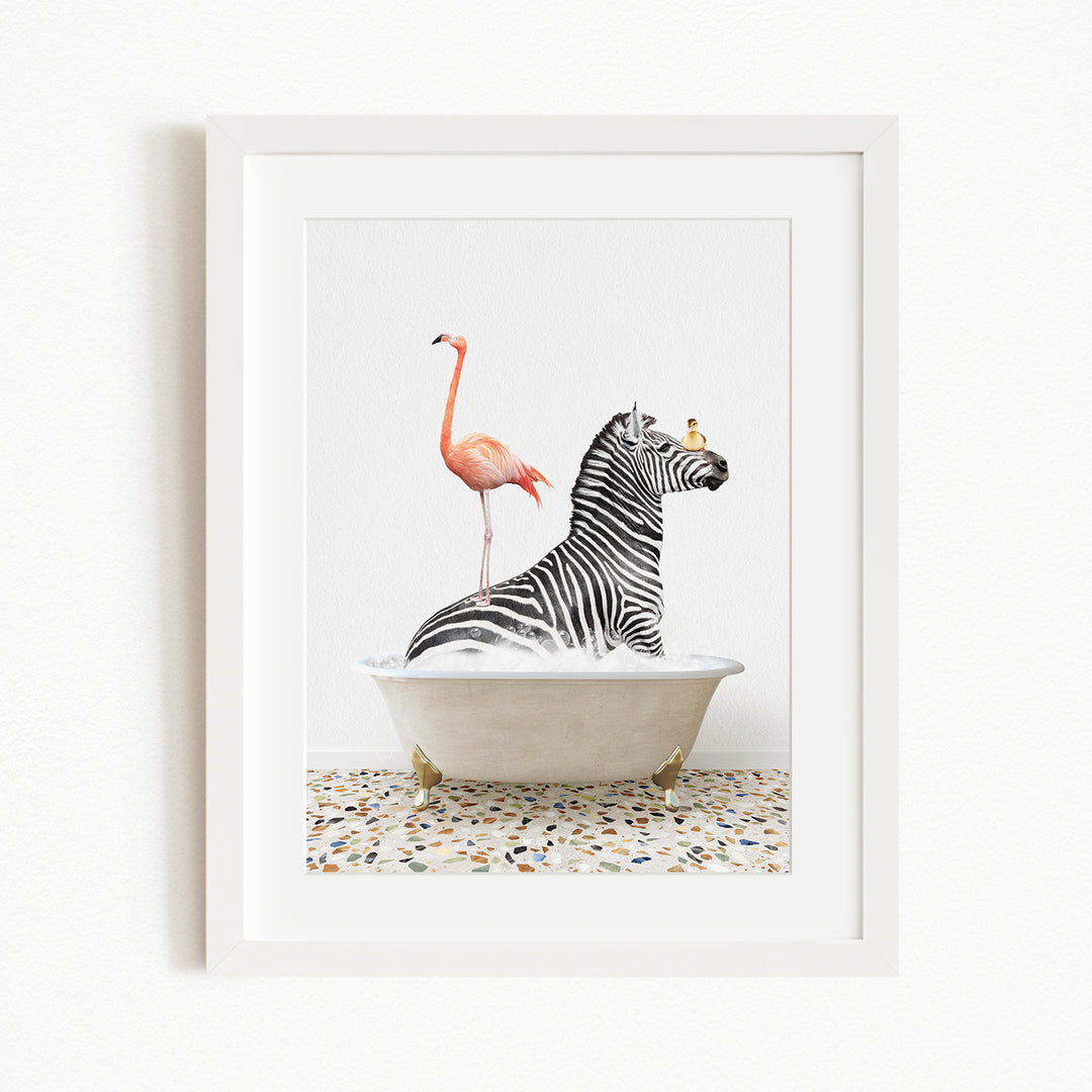 A framed image depicting a zebra sitting in a bathtub, with a flamingo standing on its back and a bird perched on its head.