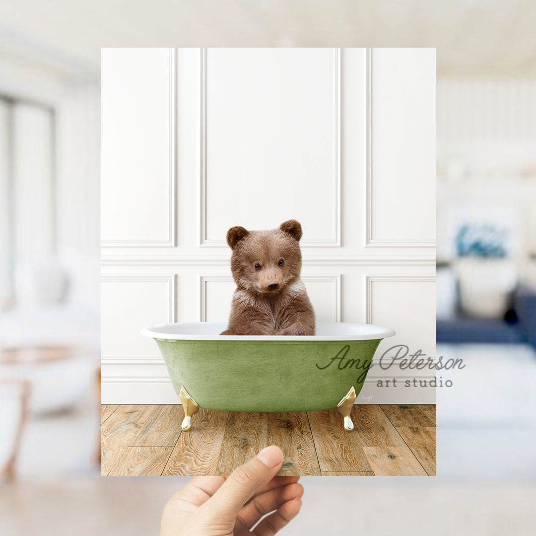 a small brown bear sitting in a green bath tub