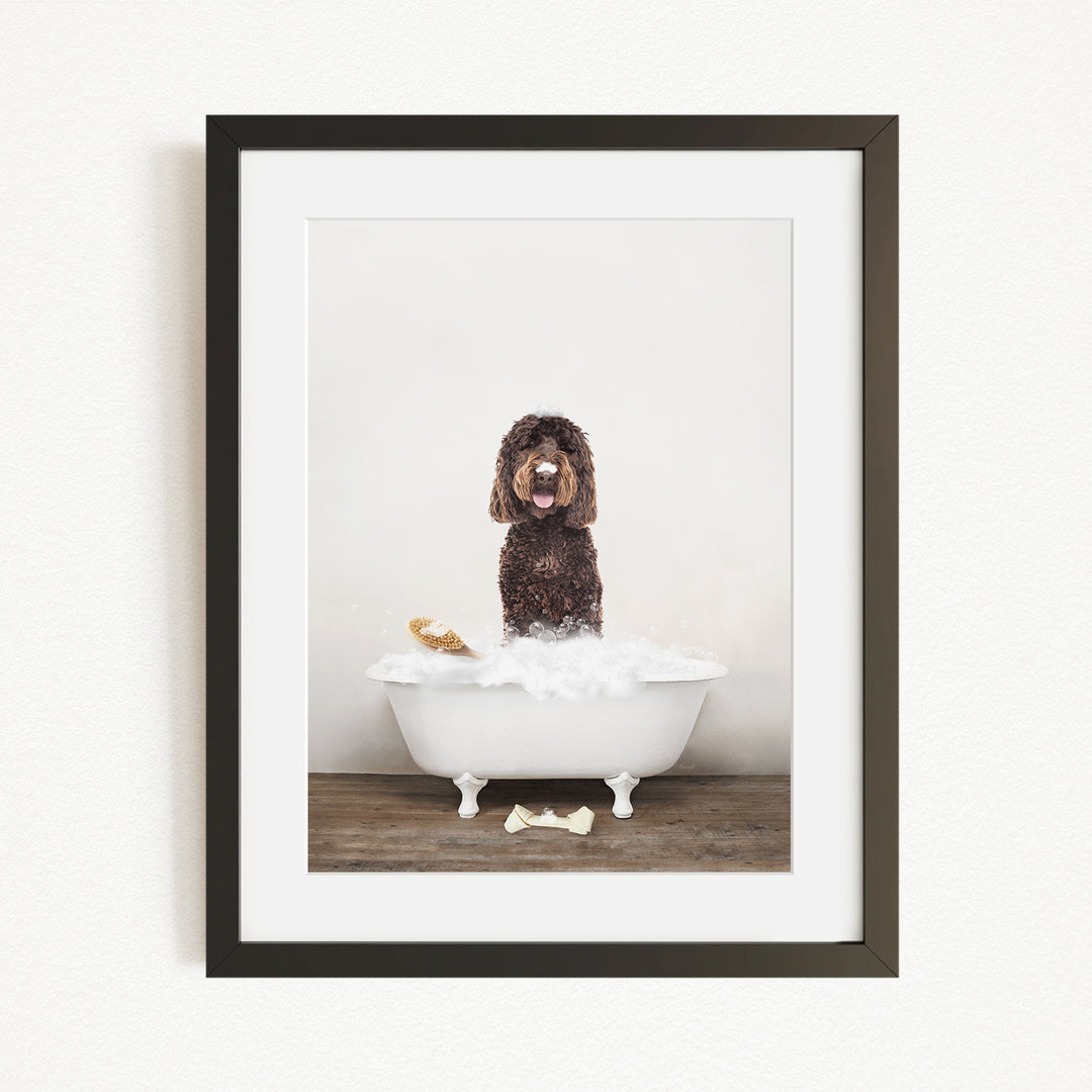 A brown dog standing in a white bathtub filled with water, with a bone on the floor.