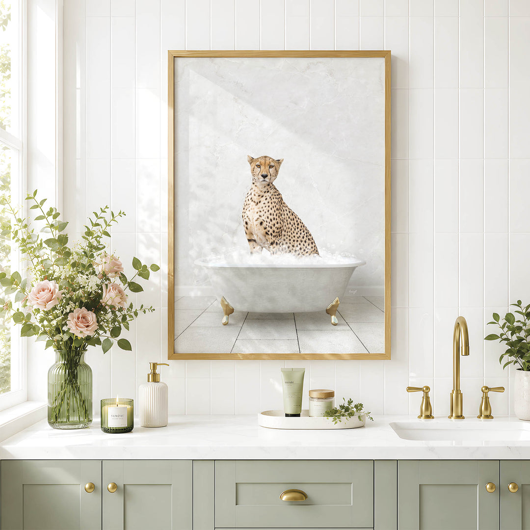 a cheetah sitting in a bathtub, surrounded by a vase of flowers, candles, and a framed picture on a white tiled wall.