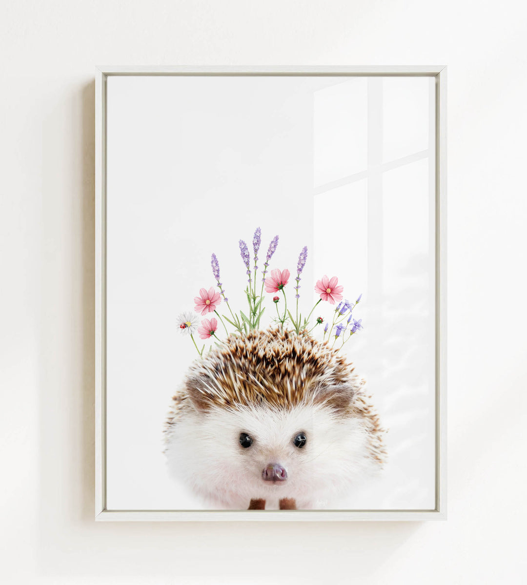 A framed image of a hedgehog with flowers on its head.
