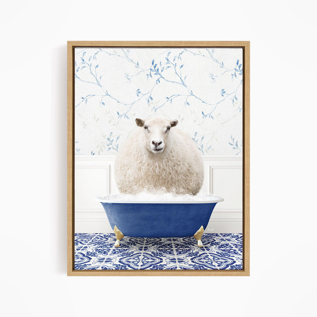 A fluffy white sheep sits in a blue bathtub, surrounded by a patterned tile floor and a floral wallpaper background.