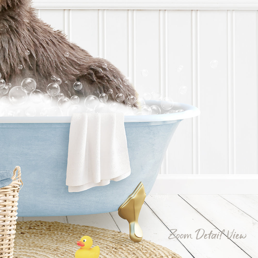 A fluffy brown dog is sitting in a blue bathtub filled with bubbles, surrounded by a yellow rubber duck and a white towel.