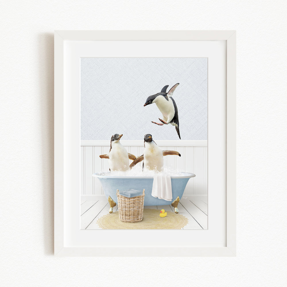 A framed image depicting two penguins sitting in a bathtub, with one penguin flying towards the other penguin.