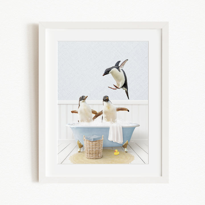 A framed image depicting two penguins sitting in a bathtub, with one penguin flying towards the other penguin.