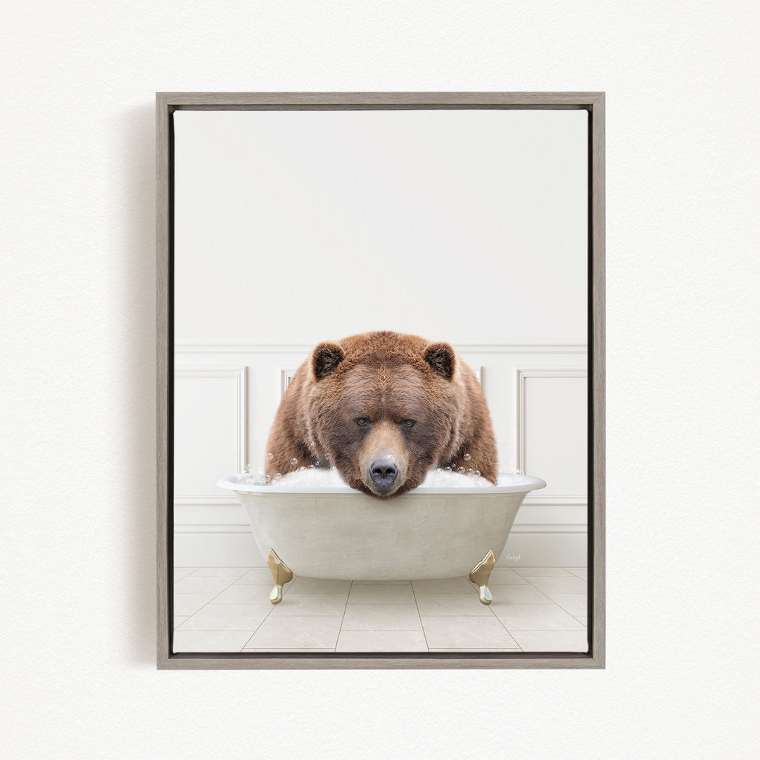 A brown bear is sitting in a white bathtub filled with water, appearing to be enjoying a relaxing bath.