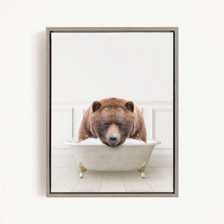 A brown bear is sitting in a white bathtub filled with water, appearing to be enjoying a relaxing bath.