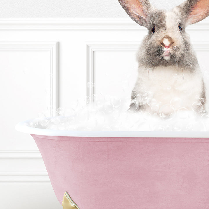 a rabbit sitting in a bathtub with bubbles