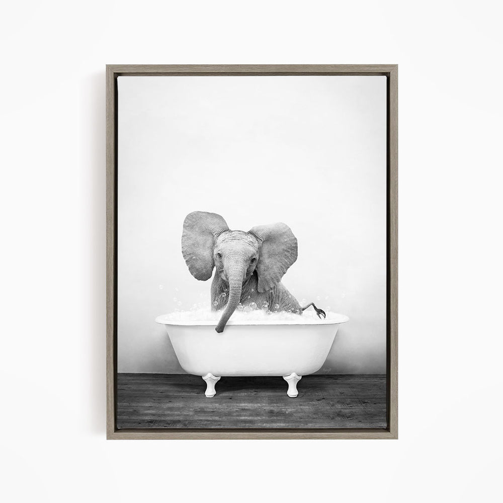 A baby elephant sitting in a bathtub filled with water, creating a playful and whimsical scene.