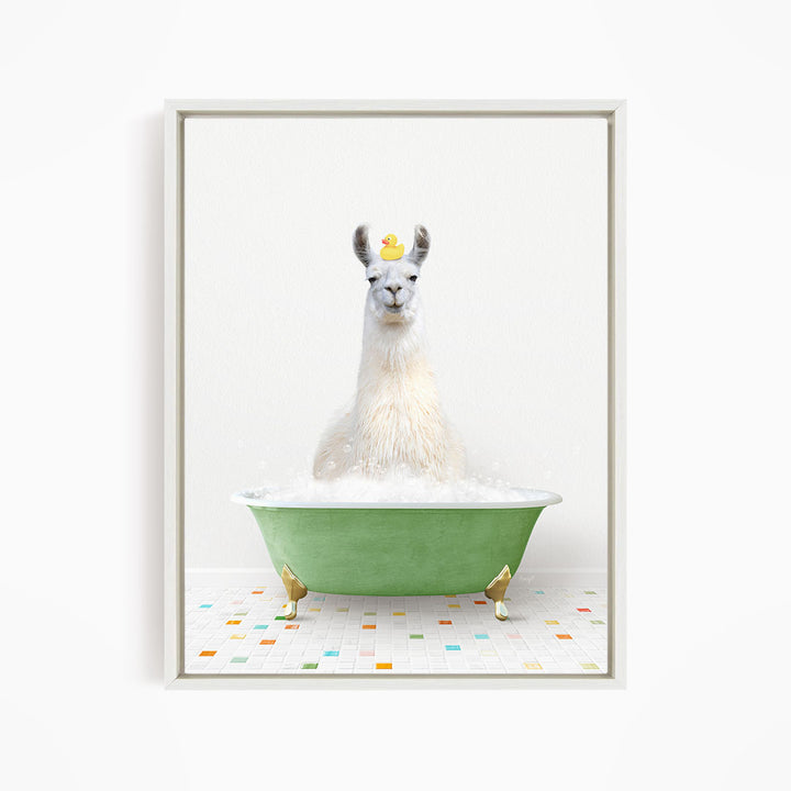A white llama sitting in a green bathtub filled with bubbles, with a yellow rubber duck floating on its head.