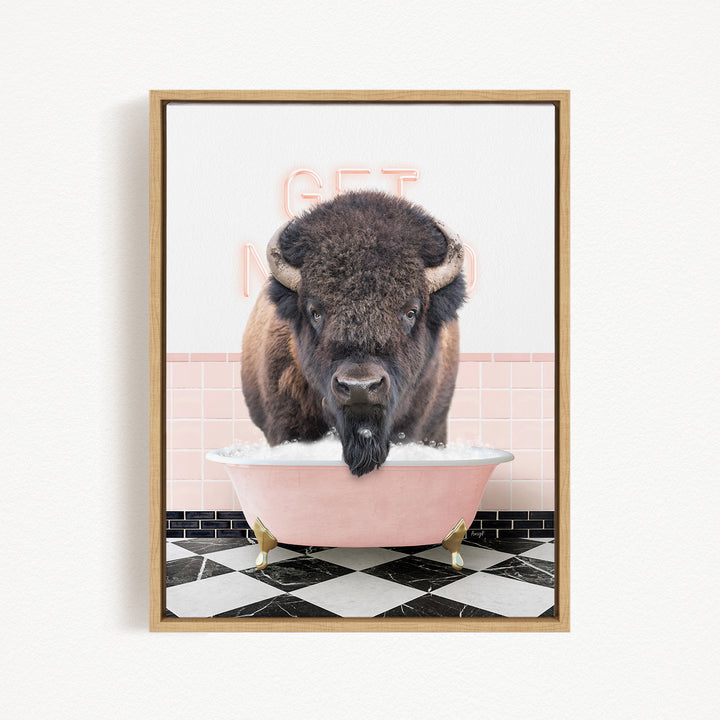 A buffalo with a long beard is sitting in a pink bathtub, with a pink and white checkered floor and a pink wall behind it.