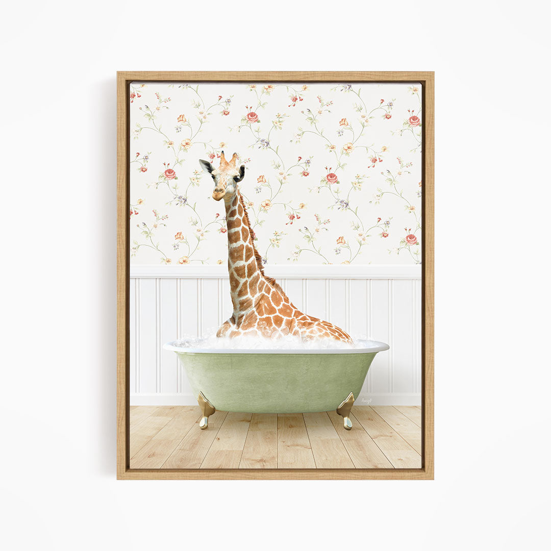 A giraffe is sitting in a green bathtub, surrounded by a floral wallpaper.