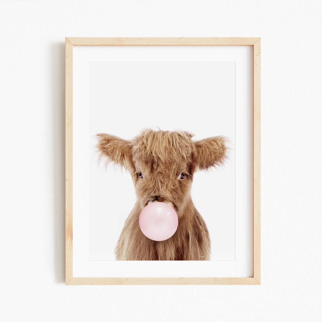 a picture of a cow with a bubble gum in its mouth