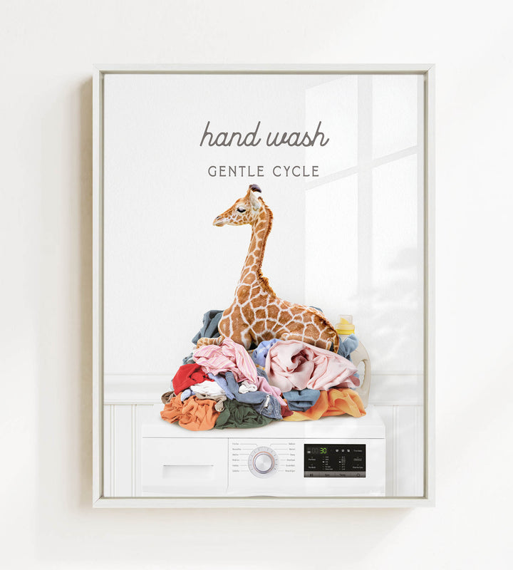 A giraffe sitting on a pile of laundry, with the text "hand wash gentle cycle" above it.