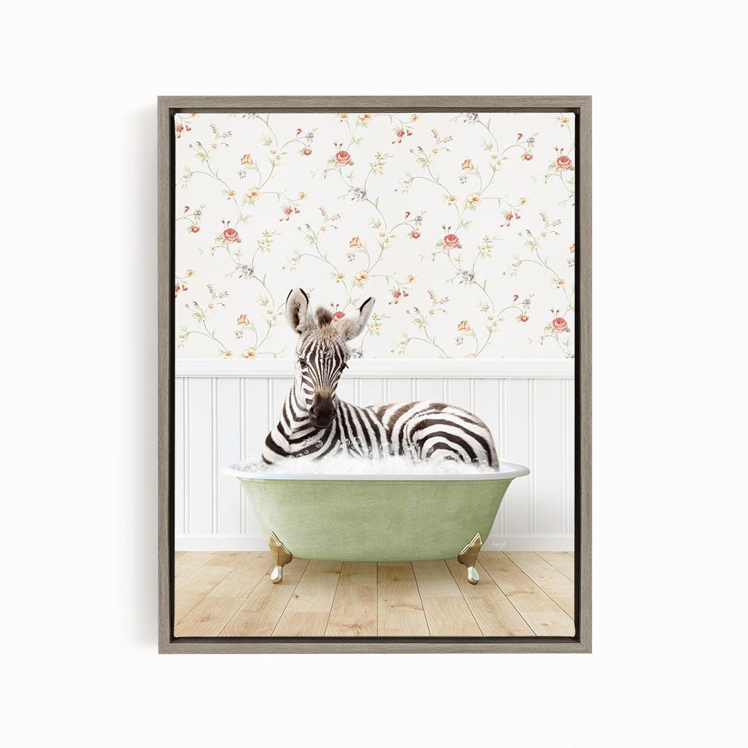 A zebra is sitting in a green bathtub, surrounded by a floral wallpaper.