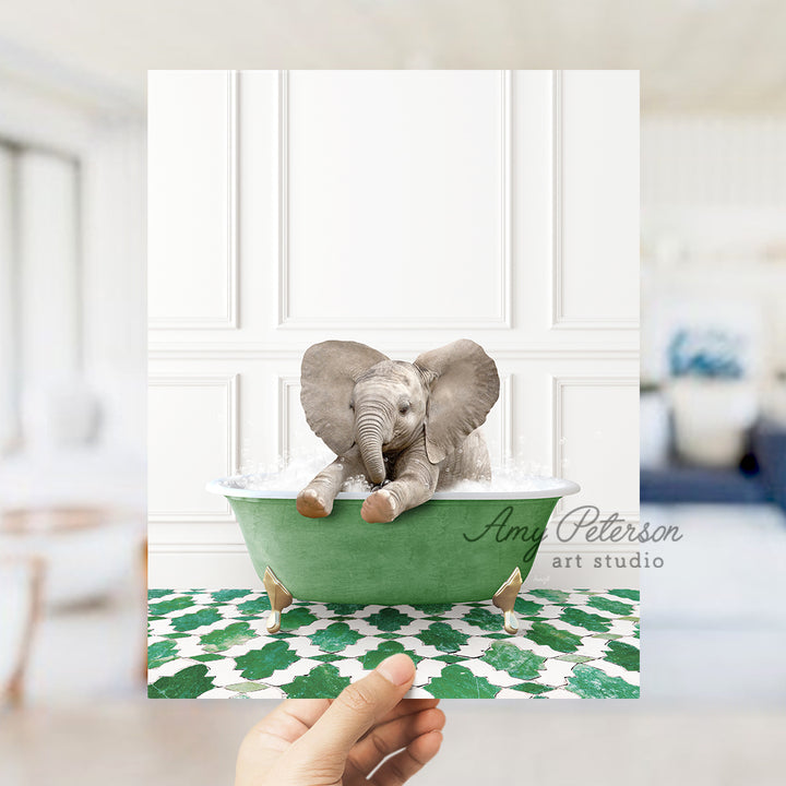 a person holding up a card with an elephant in a bathtub