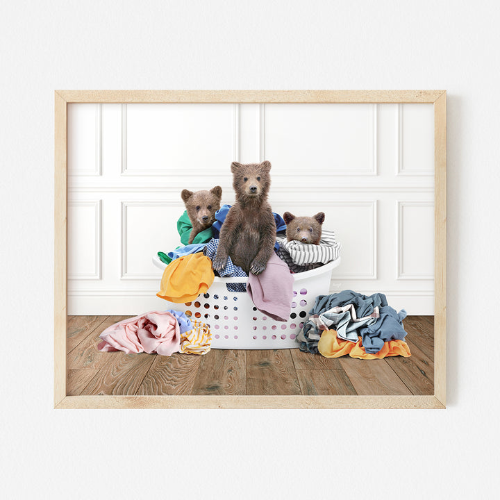 three teddy bears sitting in a laundry basket