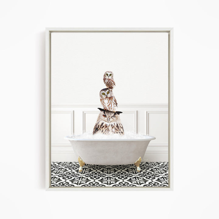 A framed image depicting three owls sitting in a white bathtub filled with water, creating a whimsical and playful scene.