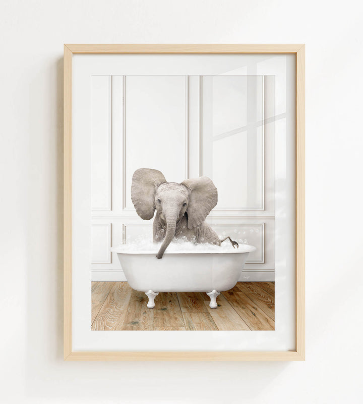 A baby elephant sitting in a white bathtub, surrounded by a wooden floor.